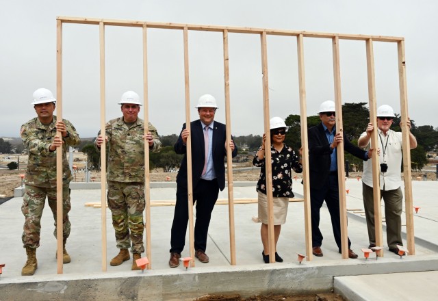 From left, Col. Varman Chhoeung, commander of U.S. Army Garrison Presidio of Monterey; Command Sgt. Maj. Robert Londers, command sergeant major of USAG PoM; Steve Bickel, deputy garrison commander; USAG PoM, Lucy Bautista, housing management program analyst; PoM Directorate of Public Works, Oscar Ordonez, PoM DPW chief of housing; and Jack Poling, PoM DPW director, pose for a photo with the first vertical wall of the Lower Stilwell housing development at the Ord Military Community, Calif., Sept. 8.