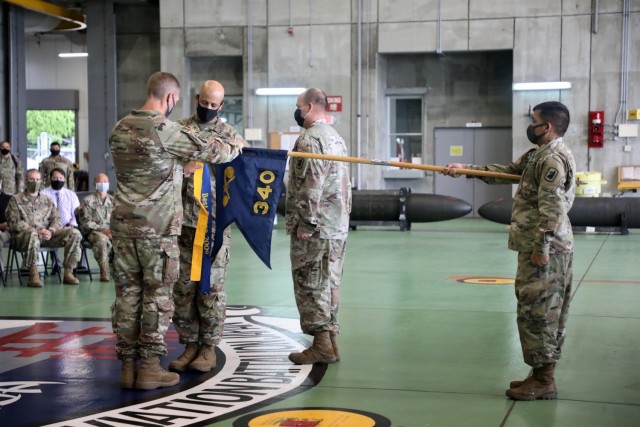 CAMP ZAMA, Japan - Lt. Col. Michael S. Omodt, USAAB-J commander, and CSM Dexter Clemons, USAAB-J senior enlisted advisor, attach the Maj. Gen. William L. Sibert Award for Excellence streamer on the 340th Chemical Company guidon during an award ceremony, Sept. 3. The 340th won the 2021 award for its support to U.S. Army Japan during its deployment here. The annual Sibert award program is designed to provide deserving recognition for excellence in the U.S. Army Chemical Corps, while instilling pride and reinforcing the essential elements of mission readiness, leadership, discipline, unit training, safety, reenlistment, maintenance and organizational excellence.