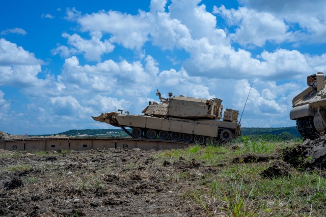 GREYWOLF Engineers with 3rd Brigade Engineer Battalion, 3rd Armored Brigade Combat Team, 1st Cavalry Division, roll across a Joint Assault Bridge (JAB) during a combined arms breach exercise, Fort Hood, Texas, June 6, 2021. The exercise included 3rd Battalion, 8th Cavalry Regiment and 2nd Battalion, 82nd Field Artillery Regiment; marking the first time in history that both an M1A2 SEPv3 Abrams Main Battle Tank and a M109A7 Paladin have crossed over the JAB. (U.S. Army photo by Sgt. Calab Franklin)
