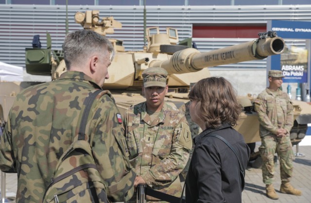 U.S. Army 1st Lt. Kobe Miller (center), an armor officer assigned to 2nd Battalion, 34th Armored Regiment, 1st Armored Brigade Combat Team, 1st Infantry Division, explains the capabilities of the M1A2 SEP v2 Main Battle Tank (Abrams) to a Polish soldier at an international defense industry exhibition known as Międzynarodowy Salon Przemysłu Obronnego in Kielce, Poland, Sept. 8, 2021. MSPO is a high-profile, international exhibition designed to showcase the latest land, sea, air and national security defense systems and military projects to a highly specialized audience from the Polish and international community. The 1st Infantry Division represented the U.S. Army at the event, showcasing equipment reflecting their armored and aviation rotational forces currently supporting Atlantic Resolve across Europe. 