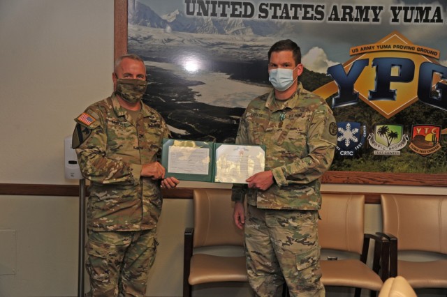 Yuma Proving Ground Commander Col. Patrick McFall and Command Sgt. Maj. Herbert Gill presented Maj. Joshua Chase with the Army Commendation Medal on behalf of the Secretary of the Army.