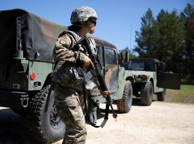 Spc. Cheyenne Kumar, a human resource specialist with the Training Support Unit out of Camp Ripley, Minn., and currently training with the 147th Human Resources Command, Minnesota National Guard, provides security Aug. 16, 2021, at an entry...