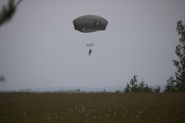 A Soldier with 1st Squadron, 91st Cavalry Regiment, 173rd Infantry Brigade Combat Team (Airborne) parachutes to the ground at U.S. Army Garrison Grafenwöhr Training Area, Germany. Chief Warrant Officer 2 Erin Allen, a pilot with 2nd General Support Aviation Battalion, 1st Aviation Regiment “Fighting Eagles,” 1st Aviation Combat Brigade and other pilots were qualifying on static-line operations June 9, 15 and 16, 2021, during their deployment as a rotational force to Europe in support of Atlantic Resolve. A rotational forward presence throughout Europe enables deterrence and defense against threats from any direction at any time. 