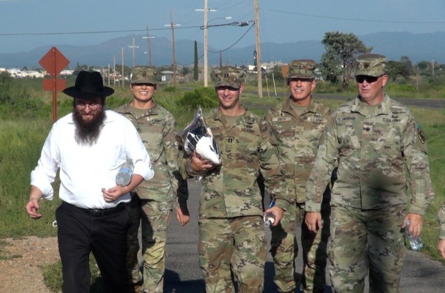Rabbi Benzion Shemtov, a religious leader who serves Fort Huachuca, Ariz. walks on Fort Huachuca, Ariz. accompanied by Soldiers en route to the Main Post Chapel where he will lead a Rosh Hashanah service to celebrate the Jewish New Year. 