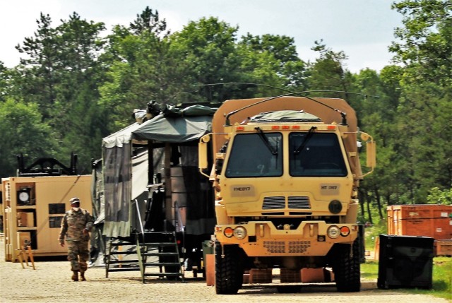 Soldiers prepare a mobile kitchen trailer for use Aug. 9, 2021, as part of operations for Combat Support Training Exercise 78-21-02 at Big Sandy Lake on South Post at Fort McCoy, Wis. Food rations used for the mobile kitchen trailer were made...