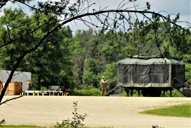 Soldiers prepare a mobile kitchen trailer for use Aug. 9, 2021, as part of operations for Combat Support Training Exercise 78-21-02 at Big Sandy Lake on South Post at Fort McCoy, Wis. Food rations used for the mobile kitchen trailer were made...