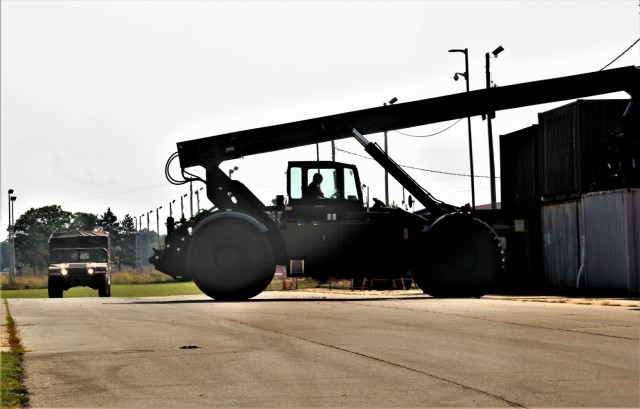 An operator with the Fort McCoy Logistic Readiness Center (LRC) Transportation Division Unit Movements Section operates an Army Standard 50,000-pound-capable Rough Terrain Container Handler (RTCH) on Aug. 20, 2021, at the division’s building on...