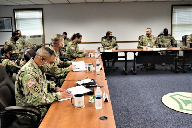 The 40th Chief of Staff of the U.S. Army Gen. James McConville (left) and other distinguished visitors listen as Fort McCoy Garrison Commander Col. Michael Poss gives a briefing Aug. 11, 2021, about the installation at the Fort McCoy (Wis.)...