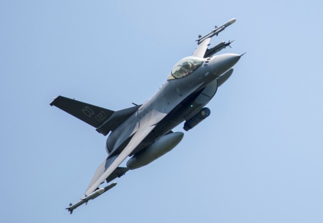 An Air Force F-16 Fighting Falcon flies over Fort McCoy, Wis., on Aug. 13, 2021. The fighter jet was participating in the Northern Lightning 2021 exercise at nearby Volk Field, Wis. F-16s also dropped 500-pound Joint Direct Attack Munitions for...
