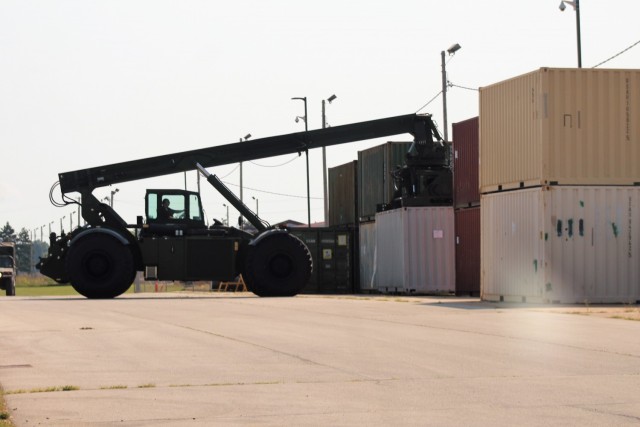 An operator with the Fort McCoy Logistic Readiness Center (LRC) Transportation Division Unit Movements Section operates an Army Standard 50,000-pound-capable Rough Terrain Container Handler (RTCH) on Aug. 20, 2021, at the division’s building on...