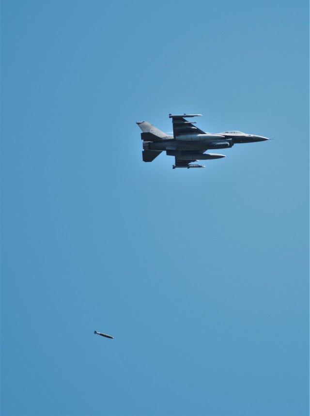 An Air Force F-16 Fighting Falcon flies over Fort McCoy, Wis., on Aug. 13, 2021. The fighter jet was participating in the Northern Lightning 2021 exercise at nearby Volk Field, Wis. F-16s also dropped 500-pound Joint Direct Attack Munitions for...