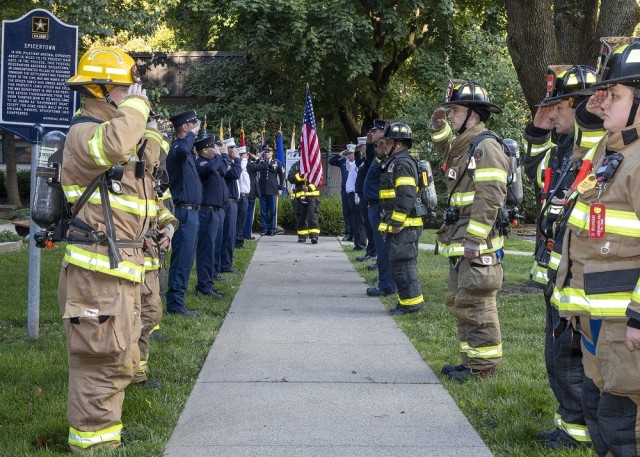 Members of the Picatinny Arsenal Fire Department salute the colors, marking the start of the installation&#39;s moving flag tribute on September 11, 2021.