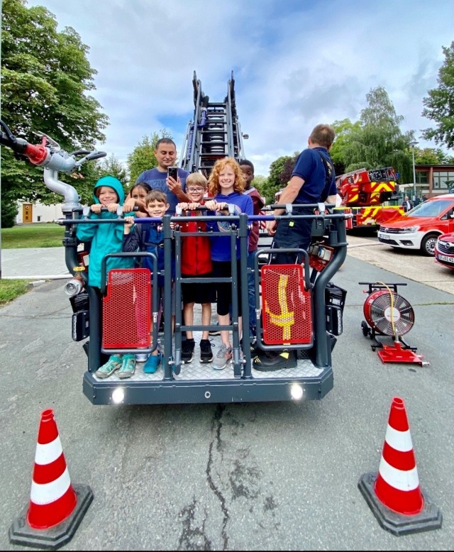 A group of children gets ready for their ride in the ladder truck at First Responders Day on August 19, 2021.