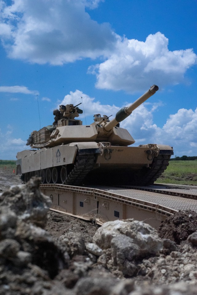 Tankers with 3rd Battalion, 8th Cavalry Regiment, 3rd Armored Brigade Combat Team, 1st Cavalry Division, trek over a Joint Assault Bridge (JAB) in their M1A2 SEPv3 Abrams Main Battle Tank during a combined arms breach exercise, Fort Hood, Texas, June 6, 2021. The exercise included 3rd Brigade Engineer Battalion and 2nd Battalion, 82nd Field Artillery Regiment; marking the first time in history that both an M1A2 SEPv3 Abrams and a M109A7 Paladin have crossed over the JAB. (U.S. Army photo by Sgt. Calab Franklin)