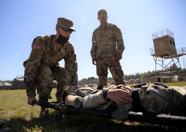 Pfc. Trevor Ulrick, a human resources specialist with the 147th Human Resources Command, Minnesota National Guard, lifts a litter Aug. 16, 2021, carrying a Soldier, Spc. Casier Young, a human resources specialist with the 147th, acting as a...
