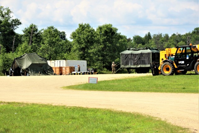 Soldiers prepare a mobile kitchen trailer for use Aug. 9, 2021, as part of operations for Combat Support Training Exercise 78-21-02 at Big Sandy Lake on South Post at Fort McCoy, Wis. Food rations used for the mobile kitchen trailer were made...