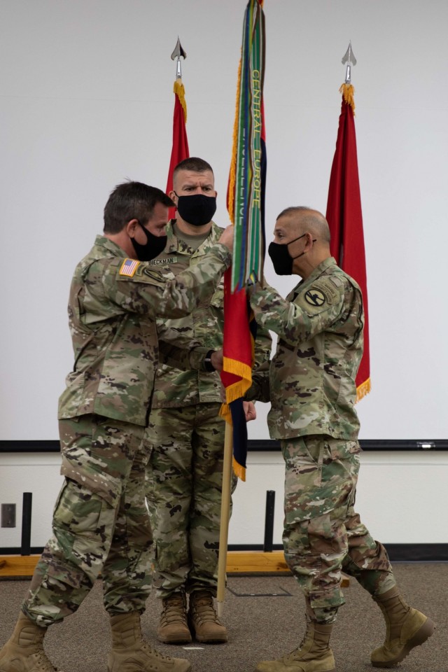 Brig. Gen. Robert E. Guidry, incoming commanding general, 86th Training Division, accepts the unit colors from Maj. Gen. Miguel A. Castellanos, commanding general, 84th Training Division and ceremony officiant, signifying his assumption of command...