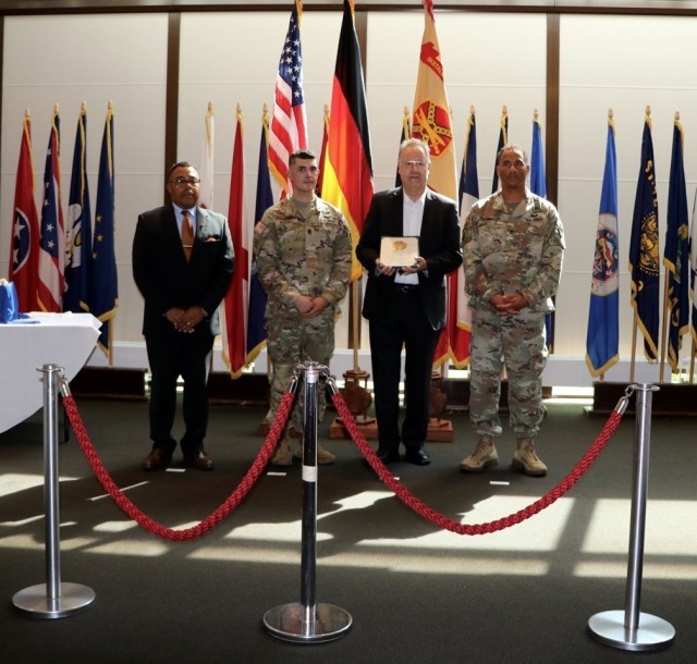 Klaus Herbst from the Directorate of Public Works, is recognized for his 45 years of civilian service to the Army as Deputy to the Garrison Commander Mitchell Jones, Garrison Command Sgt. Maj. Richard Russell and Garrison Commander Col. Mario...