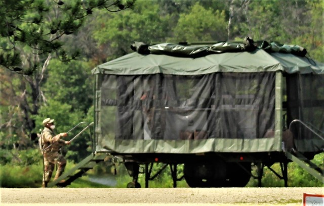 Soldiers prepare a mobile kitchen trailer for use Aug. 9, 2021, as part of operations for Combat Support Training Exercise 78-21-02 at Big Sandy Lake on South Post at Fort McCoy, Wis. Food rations used for the mobile kitchen trailer were made...