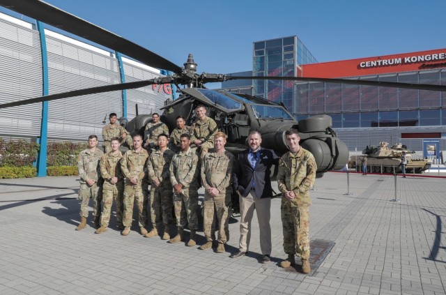 Members of the 1st Infantry Division’s 1st Armored Brigade Combat Team and 1st Combat Aviation Brigade gather for a photo with Anthony Sebrell, the armaments cooperation and trade show coordinator for U.S. Army Europe and Africa, during an international defense industry exhibition known as Międzynarodowy Salon Przemysłu Obronnego in Kielce, Poland, Sept. 10, 2021. MSPO is a high-profile, international exhibition designed to showcase the latest land, sea, air and national security defense systems and military projects to a highly specialized audience from the Polish and international community. The 1st Infantry Division represented the U.S. Army at the event, showcasing equipment reflecting their armored and aviation rotational forces currently supporting Atlantic Resolve across Europe. 