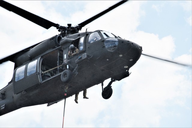 A Wisconsin Army National Guard UH-60 Black Hawk aircrew with the Madison, Wis.-based 1st Battalion, 147th Aviation Regiment train to drop water on wildfires Aug. 12, 2021, using Bambi buckets at a lake at Fort McCoy, Wis., in preparation for...