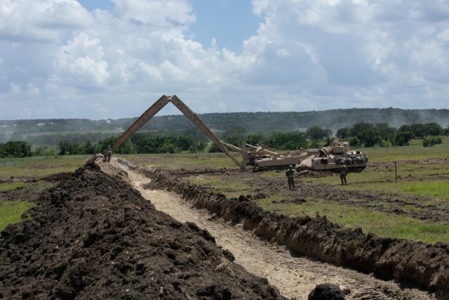 GREYWOLF Engineers with 3rd Brigade Engineer Battalion, 3rd Armored Brigade Combat Team, 1st Cavalry Division, lower the base on a Joint Assault Bridge (JAB) during a combined arms breach exercise, Fort Hood, Texas, June 6, 2021. The exercise included 3rd Battalion, 8th Cavalry Regiment and 2nd Battalion, 82nd Field Artillery Regiment; marking the first time in history that both an M1A2 SEPv3 Abrams Main Battle Tank and a M109A7 Paladin have crossed over the JAB. (U.S. Army photo by Sgt. Calab Franklin)
