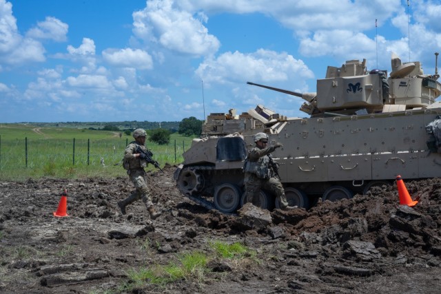 Engineers with 3rd Brigade Engineer Battalion, 3rd Armored Brigade Combat Team, 1st Cavalry Division, prep the exit point to a Joint Assault Bridge (JAB) during a combined arms breach exercise, Fort Hood, Texas, June 6, 2021. The exercise included 3rd Battalion, 8th Cavalry Regiment and 2nd Battalion, 82nd Field Artillery Regiment; marking the first time in history that both an M1A2 SEPv3 Abrams Main Battle Tank and a M109A7 Paladin have crossed over the JAB. (U.S. Army photo by Sgt. Calab Franklin)