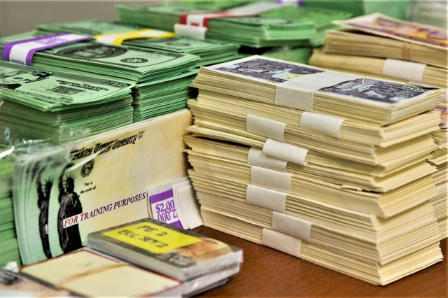 Exercise props, including play currency, EagleCash cards and mock Treasury checks, sit ready for use during the Diamond Saber exercise Aug. 14, 2021, at Fort McCoy, Wis. Diamond Saber is a U.S. Army Reserve-led exercise that incorporates participation from all components and joint services, and it prepares finance and comptroller Soldiers on the warfighting functions of funding the force, payment support, disbursing operations, accounting, fiscal stewardship, auditability and data analytics. (U.S. Army photo by Mark R. W. Orders-Woempner)