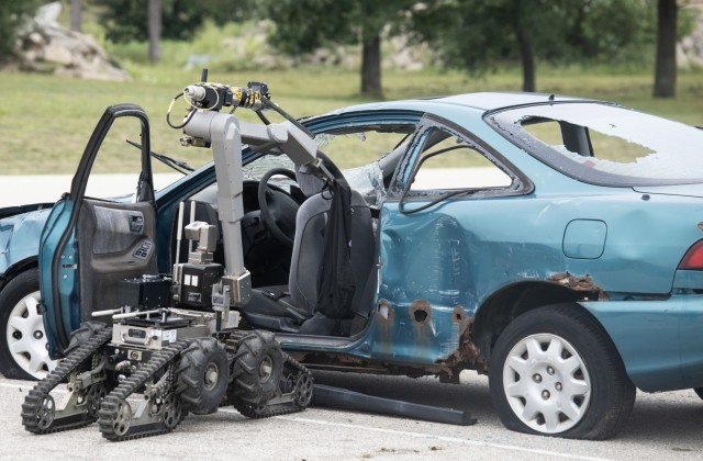 A robot is used to complete a training scenario July 28, 2021, at the Fort McCoy (Wis.) Combined Arms Collective Training Facility as part of the Audacious Warrior 2021 exercise. Since 2017, explosive ordnance disposal technicians from units...