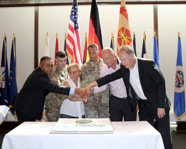The 40 and 45 year awardees, Connie Dickey, Juergen Thieme and Klaus Herbst had the honor of cutting the cake with Wiesbaden Garrison Commander, Col. Mario Washington, Garrison Command Sgt. Maj. Richard Russell and Deputy to the Garrison...