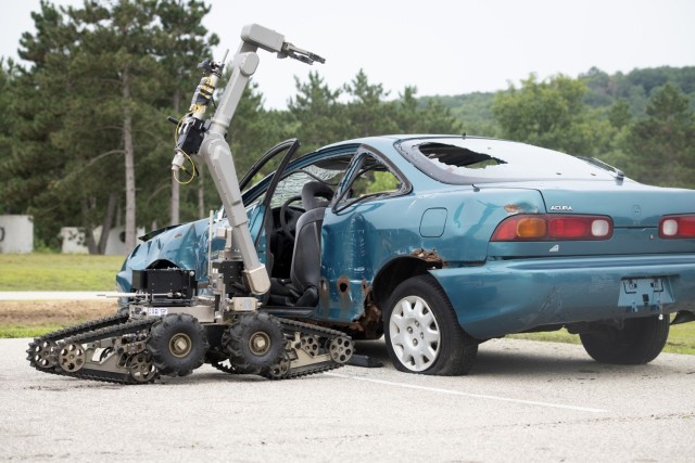 A robot is used to complete a training scenario July 28, 2021, at the Fort McCoy (Wis.) Combined Arms Collective Training Facility as part of the Audacious Warrior 2021 exercise. Since 2017, explosive ordnance disposal technicians from units...