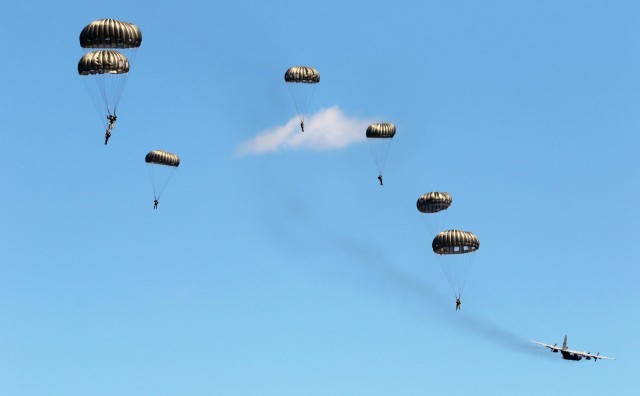 Soldiers with the 294th Quartermaster Company, 338th Quartermaster Company, Texas Army National Guard, the 3rd Special Forces Group, soldiers with the Latvian Army’s Special Forces Group and British Army’s 4th Battalion, Parachute Regiment (4 PARA), jump out of a C-130 Hercules aircraft over Camp Grayling Joint Maneuver Training Center, Grayling, Michigan, Aug. 13, 2021. The service members conducted joint airborne training during Northern Strike 21. (U.S. Army National Guard photo by Staff Sgt. Tegan Kucera)