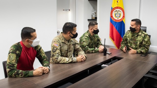 U.S. Army Chief Warrant Officer 3 Mauricio Garcia, meets with Lt. Col Milton Monroy, the Aviation Training Battalion commander, and staff at the Tolemaida Army Base, Colombia. Garcia, a UH-60M Black Hawk pilot and aviation safety officer, is deployed here as part of a technical advising team from Army Security Assistance Command’s Fort Bragg-based training unit, the Security Assistance Training Management Organization.