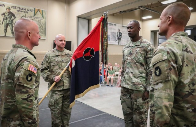 Command Sgt. Maj. Jeremy Strasser, the incoming senior enlisted leader of the 2nd Infantry Brigade Combat Team, 34th Infantry Division, Iowa Army National Guard, holds the unit colors during the change of responsibility ceremony for the 2nd...