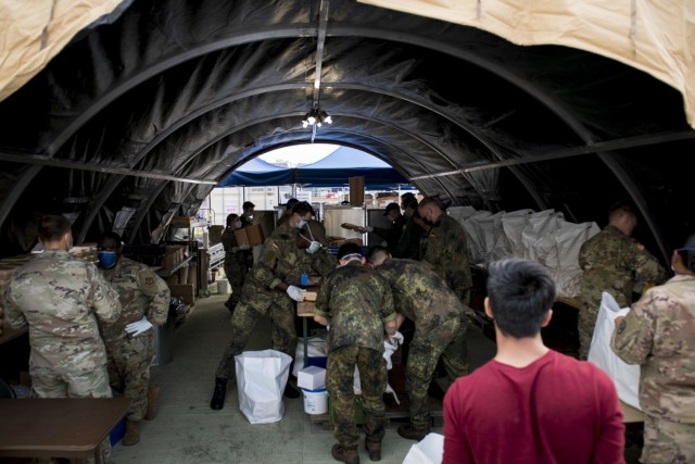 Service members from the U.S. Army and Air Force work shoulder to shoulder with soldiers from the German Bundewehr to prepare meals for the Afghanistan evacuees. Ramstein Air Base is a transit center that provides a safe place for the evacuees to complete their paperwork while security and background checks are conducted before they continue on to their final destination. (U.S. Army photo by Staff Sgt. Thomas Mort)