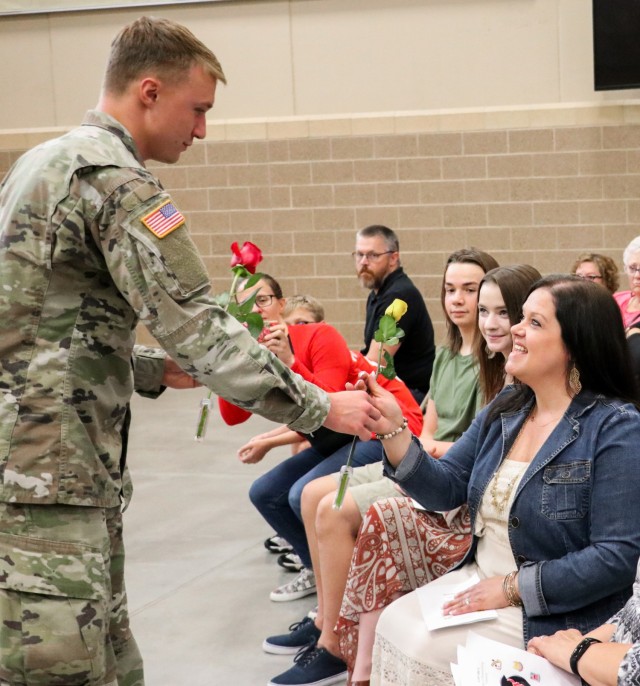Spc. Tyler Strasser, a cavalry scout with 1st Squadron, 113th Cavalry Regiment, Iowa Army National Guard, presents a rose to his aunt, Kayla Strasser, during the change of responsibility ceremony for the 2nd Infantry Brigade Combat Team, 34th...