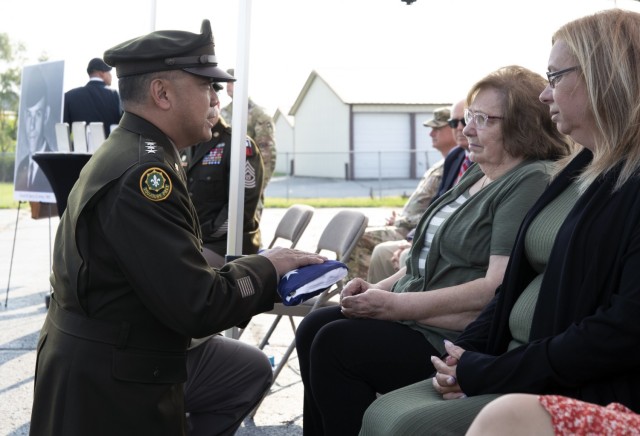 On behalf of a grateful nation, First Army Commanding General, Lt. Gen. Antonio Aguto Jr., presents a folded United States flag to Marie Nelsen, widow of Pfc. David Wayne Derry.