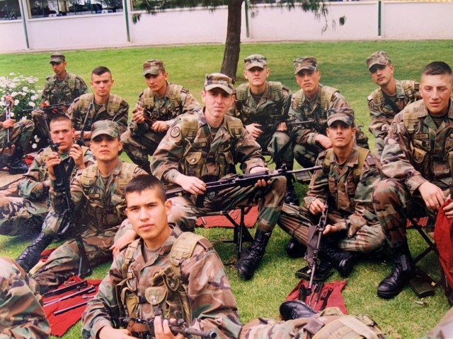 Cadet Mauricio Garcia, without hat in foreground, and fellow classmates, pose for a photo during a field exercise at the military officer school in Bogota, Colombia. Garcia, now a Chief Warrant Officer 3 with the U.S. Army, is deployed to...