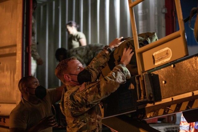 GRAFENWOEHR, Germany - V Corps Soldiers unload their luggage after arriving at Grafenwoehr, Germany, early September, in preparation for V Corps' upcoming certifying training event, Warfighter 22-1. The exercise, which will take place Sept. 27 to Oct. 6, will be V Corps' final step in becoming the U.S. Army’s fourth corps and America’s forward deployed corps in Europe. (U.S. Army photo by Daniela Vestal/Released)