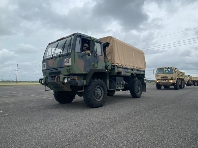 Light Medium Tactical Vehicles assigned to the Louisiana National Guard’s 527th Engineer Battalion, 225th Engineer Brigade, lead a convoy of dump trucks and flat-bottom boats to be staged in advance of Tropical Depression Nicholas at the Burton...