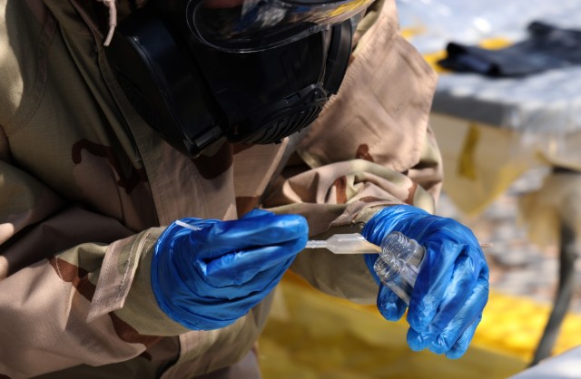 Pfc. Samantha Gonzalez, Chemical, Biological, Radiological and Nuclear (CBRN) Specialist assigned to the 46th Chemical Company (Technical Escort) carefully places a soil sample into a glass vile, Sept. 12, 2021, at the Mission Training Complex on Fort Bliss, Texas. Gonzalez and her unit were participating in a combined training exercise with CBRNE Analytical and Remediation Activity (CARA), Sept. 9-13, to validate 22nd Chemical Battalion for an upcoming mission. (U.S. Army photo by Marshall R. Mason)