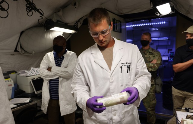 Kevin Wioland, a chemist with CBRNE Analytical and Remediation Activity (CARA), inspects a sample he received, Sept. 12, 2021, during a joint training exercise with the 22nd Chemical Battalion held at the Mission Training Complex, Fort Bliss, Texas. Wioland operated inside CARA’s heavy expeditionary mobile laboratory. (U.S. Army photo by Marshall R. Mason)