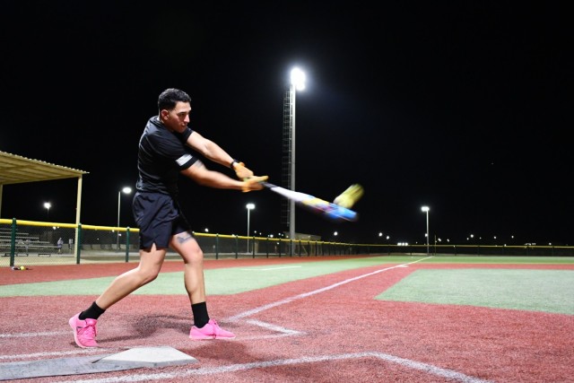 Sgt. Jeremy Paz-Rivera, an information technology specialist assigned to the Fort Bragg, N.C., based 3rd Expeditionary Sustainment Command, practices his batting skills, Sept. 13, 2021, at Camp Arifjan, Kuwait. Paz-Rivera, whose unit assumed the 1st Theater Sustainment Command’s operational command post mission in late August, was crowned the Camp Arifjan Softball Home Run Derby King for hitting 19 homeruns during a competition, Sept. 6.