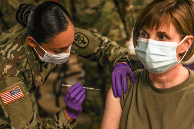 Staff Sgt. Brenda Collins, medical specialist, from Carl R. Darnall Army Medical Center administers the COVID-19 vaccination to a patient during the phase one process Dec.15, 2020 at on Fort Hood, Texas. Distribution of the vaccine will be conducted in phases based on CDC guidance. The vaccine is stored and distributed under various controls to ensure the safety of the recipient.