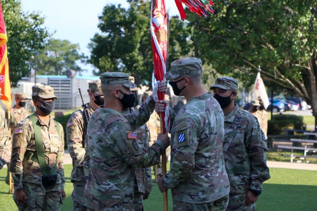Lt. Col. T. Brian Looney passes the 9th Engineer Battalion colors to Command Sgt. Maj. Jonathan Saunders, symbolizing the passing of responsibility of the battalion as the senior enlisted advisor, at Cashe Garden, Fort Stewart, Georgia, Sept. 7, 2021. The passing of the battalion colors is a time-honored tradition that signifies the change of responsibility from one command sergeant major to the next in order to serve as the units caretaker and senior enlisted advisor to the battalion commander. (U.S. Army photo by Sgt. Trenton Lowery)