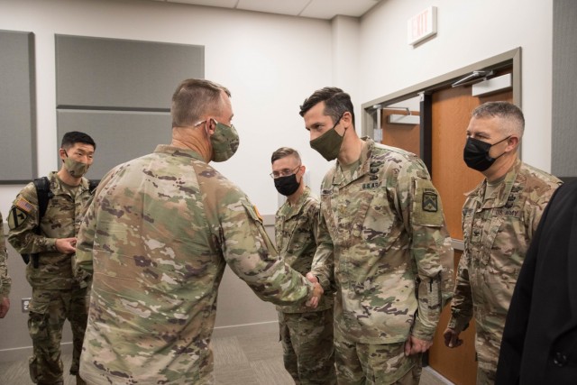 U.S. Army Gen. Paul Funk II, commanding general, Training and Doctrine Command, awards a coin of excellence to Maj. Jeremy Medaris for exemplary support during Operation Allies Refuge Aug. 5, 2021 at Ft. Lee, Virginia. The Department of Defense,...