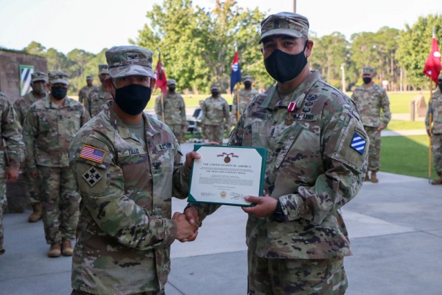 Col. Terry R. Tillis, commander of the 2nd Armored Brigade Combat Team, 3rd Infantry Division, presents Command Sgt. Maj. Oscar Rodriguez a Meritorious Service Medal during a change of responsibility ceremony at Cashe Garden, Fort Stewart,...