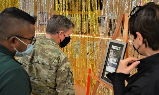 VICENZA, Italy – (From left) Davisen Poorcelan, USAG Italy Child and Youth Services youth program director, Col. Matthew J. Gomlak, garrison commander, and Olga Fiyalko, mother of BGCA’ contest winner look at one of the two art pieces that won...