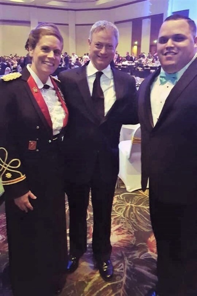 Army Reserve Lt. Col. Suzanne Rodriguez, left, with actor Gary Sinese, middle, and her husband Milton Rodriguez, right, pose during a 9th Mission Support Command military ball in 2017. Rodriguez, who currently serves as a Dept. of the Army civilian as the deputy chief of operations for the G-3, 311th Signal Command (Theater), recently completed an 11-month course at the Naval War College in Newport Rhode, Island. Rodriguez also assumed command of the 1395th Deployment and Distribution Support Battalion (DDSB) in July of this year.