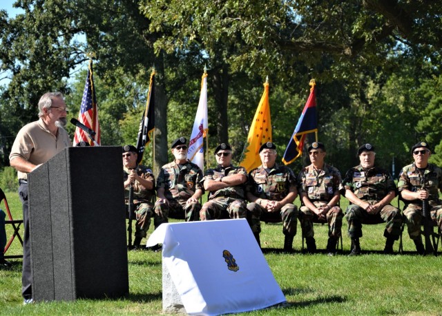 Roger Gilmore of the Americal Legacy Foundation speaks to event attendees about the importance of preserving the legacy of the division at the Americal Division Memorial Dedication at Rock Island National Cemetery in Illinois. Photo by: Staci-Jill...
